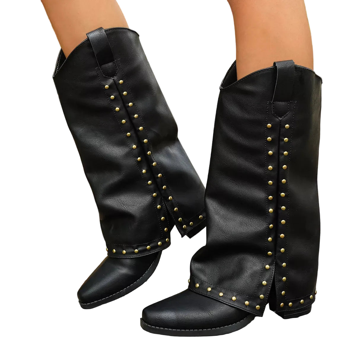 A pair of black mid-calf boots with gold-tone metal studs, shown on a person's feet standing on a wooden boardwalk outdoors.