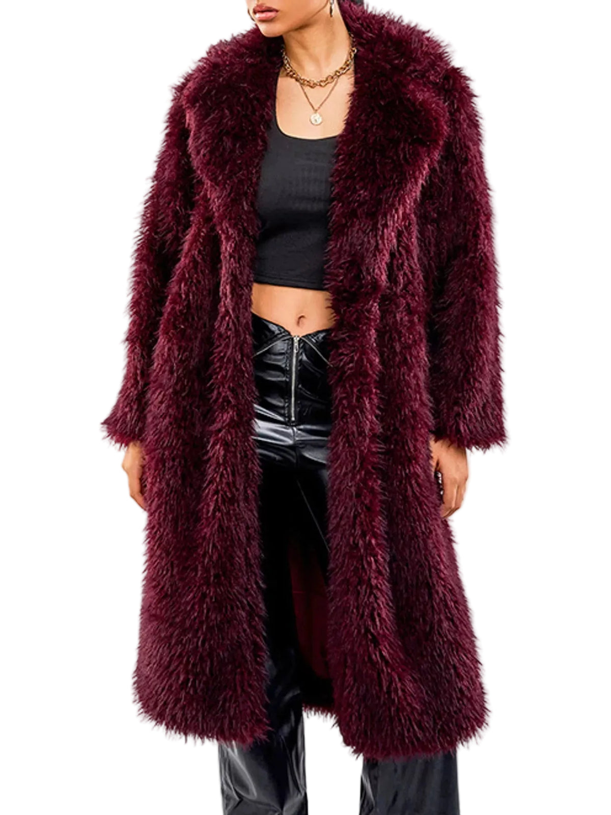 A model wearing a long, plush faux fur coat in deep burgundy, styled with a black crop top and shiny black pants against a plain white background.