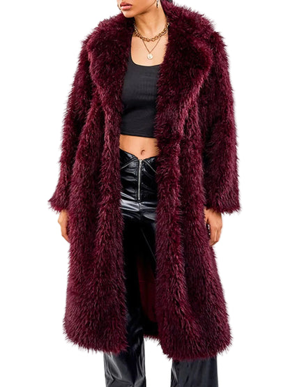 A model wearing a long, plush faux fur coat in deep burgundy, styled with a black crop top and shiny black pants against a plain white background.