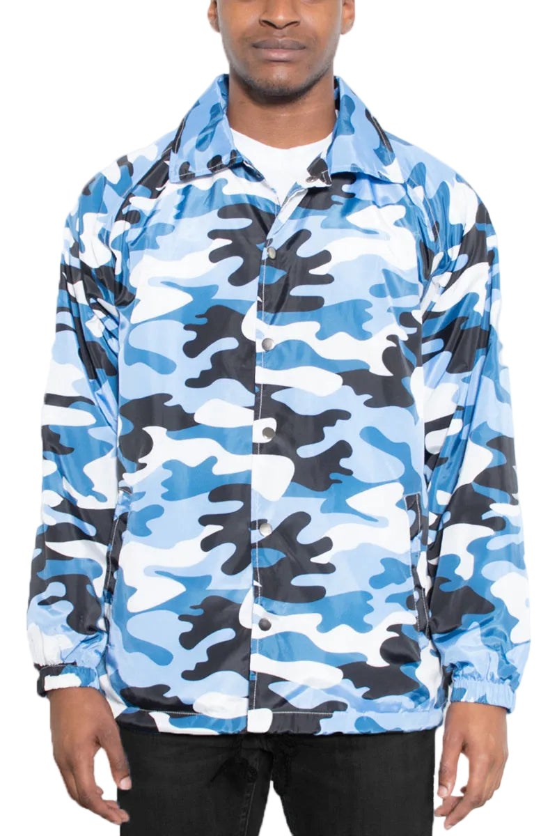 Blue and black camouflage jacket worn by a person on a white background