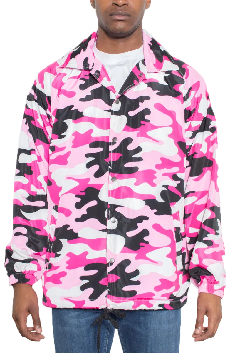 Person wearing a pink and black camouflage jacket on a white background