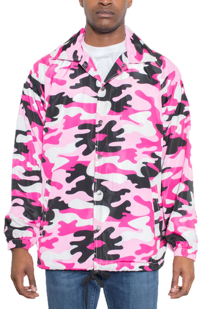 Person wearing a pink and black camouflage jacket on a white background