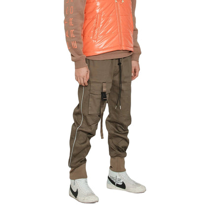 Person wearing a brown jacket with orange accents, cargo pants, and white sneakers on a white background