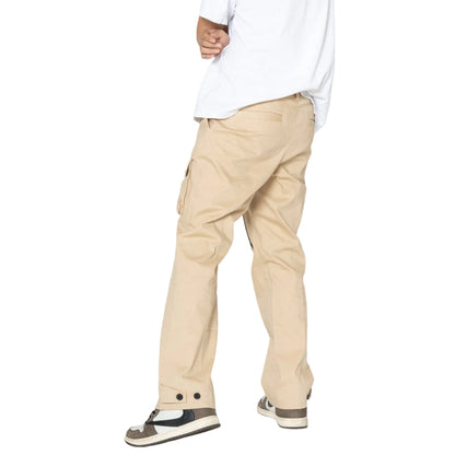 Person wearing beige pants and a white shirt on a plain background