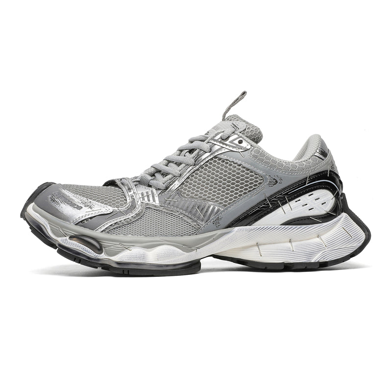 A silver and gray athletic sneaker with black and white accents, shown from a side profile on a clean white background.