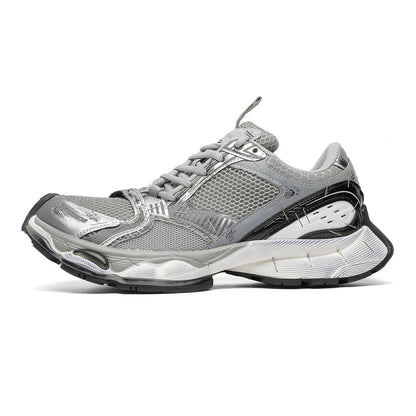 A silver and gray athletic sneaker with black and white accents, shown from a side profile on a clean white background.