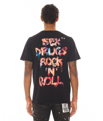 Person wearing a black t-shirt with colorful text on the back, standing against a white background