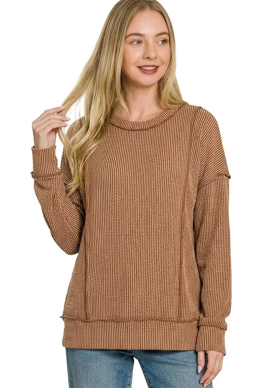 Woman wearing a brown sweater on a white background