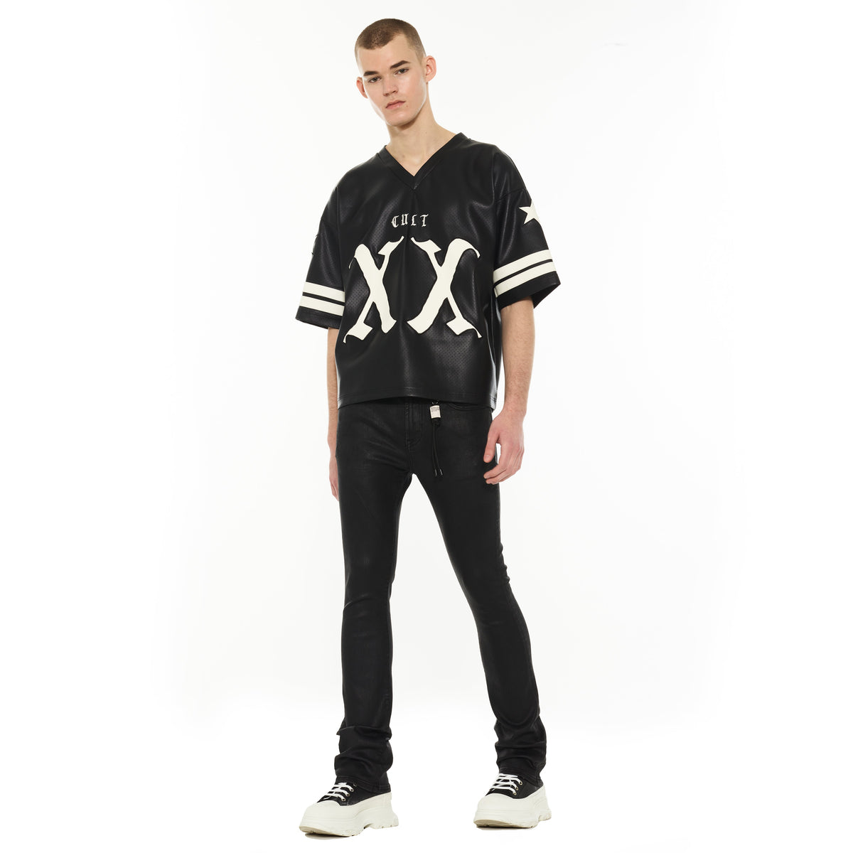 Person wearing a black and white sports jersey with 'CULT' branding on a white background