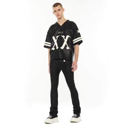 Person wearing a black and white sports jersey with 'CULT' branding on a white background