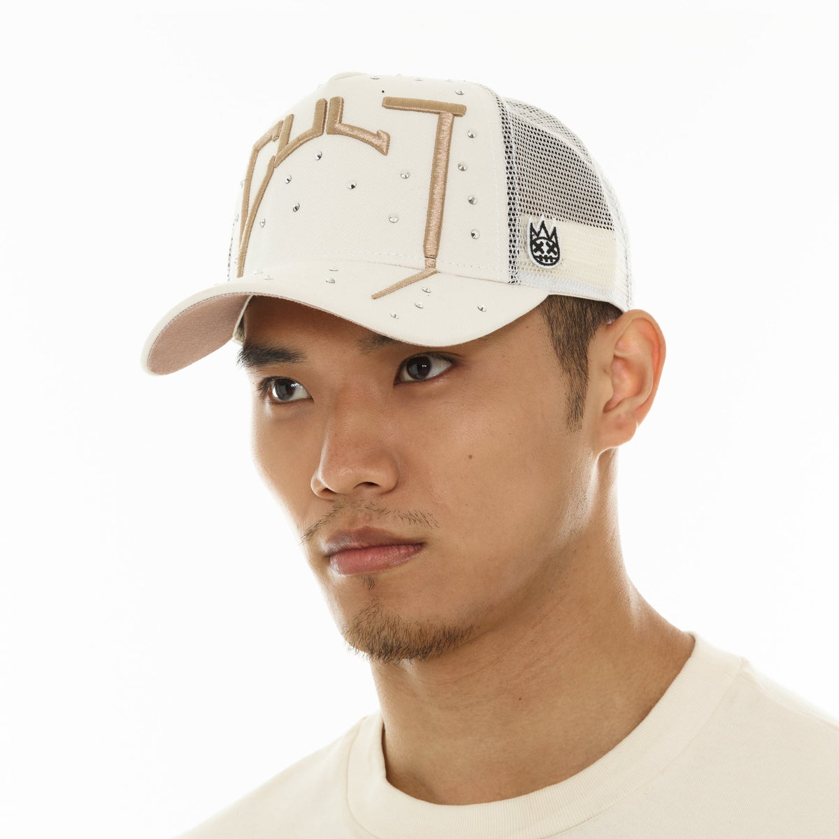 Man wearing a beige cap with a white background