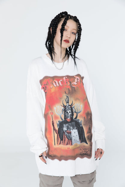 Person wearing a white sweatshirt with a graphic design on a plain background