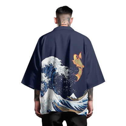 Person wearing a navy blue kimono with a fish and wave design on the back, on a light gray background.