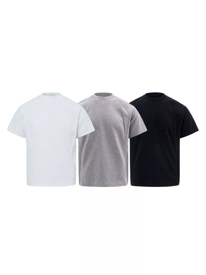Three short-sleeve crew-neck t-shirts shown side by side on a plain white background, in white, light gray, and black.