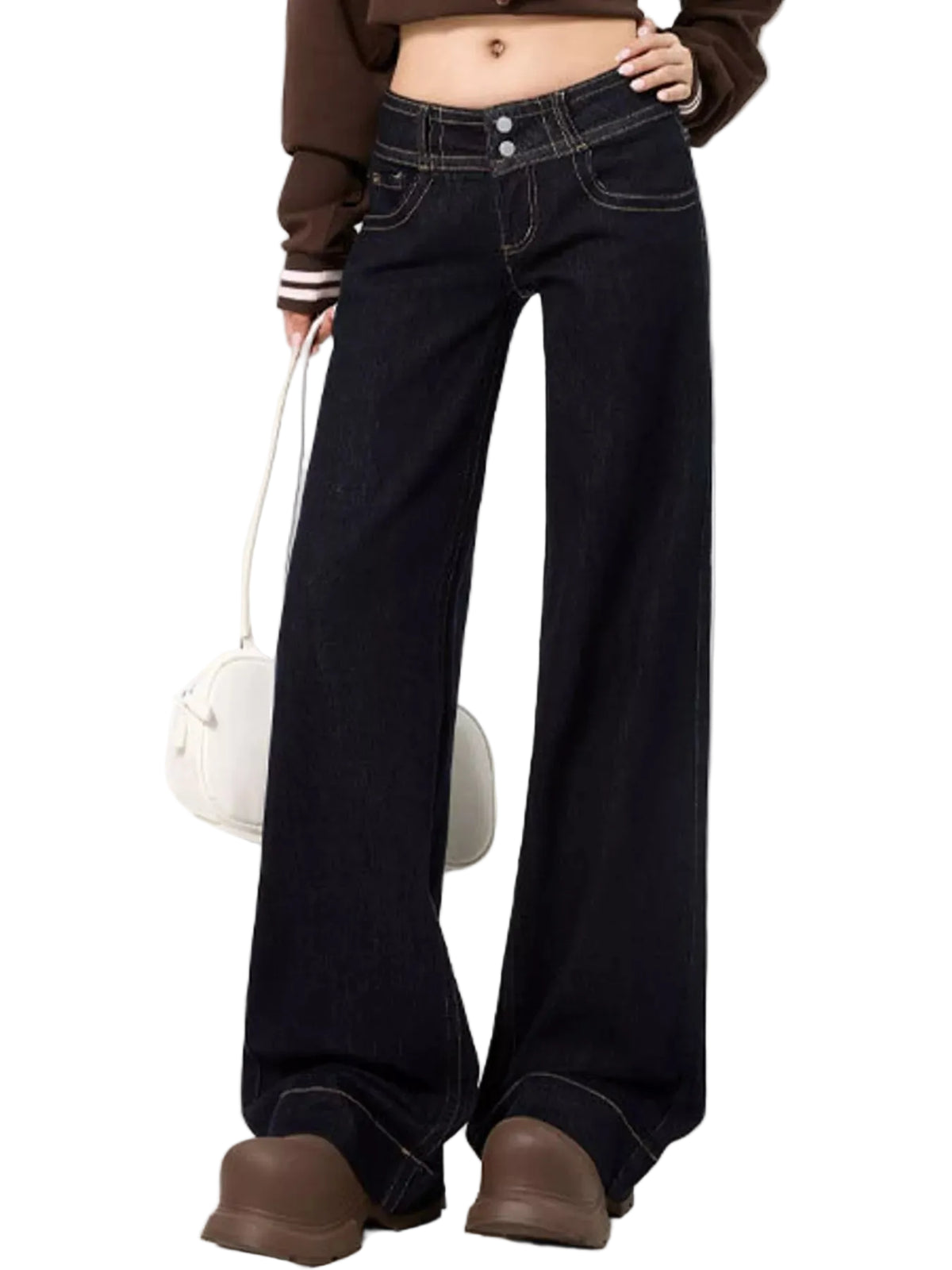A person wearing dark indigo wide-leg jeans with contrast light stitching, styled with a brown cropped sweater and brown boots, holding a white handbag against a plain white background.