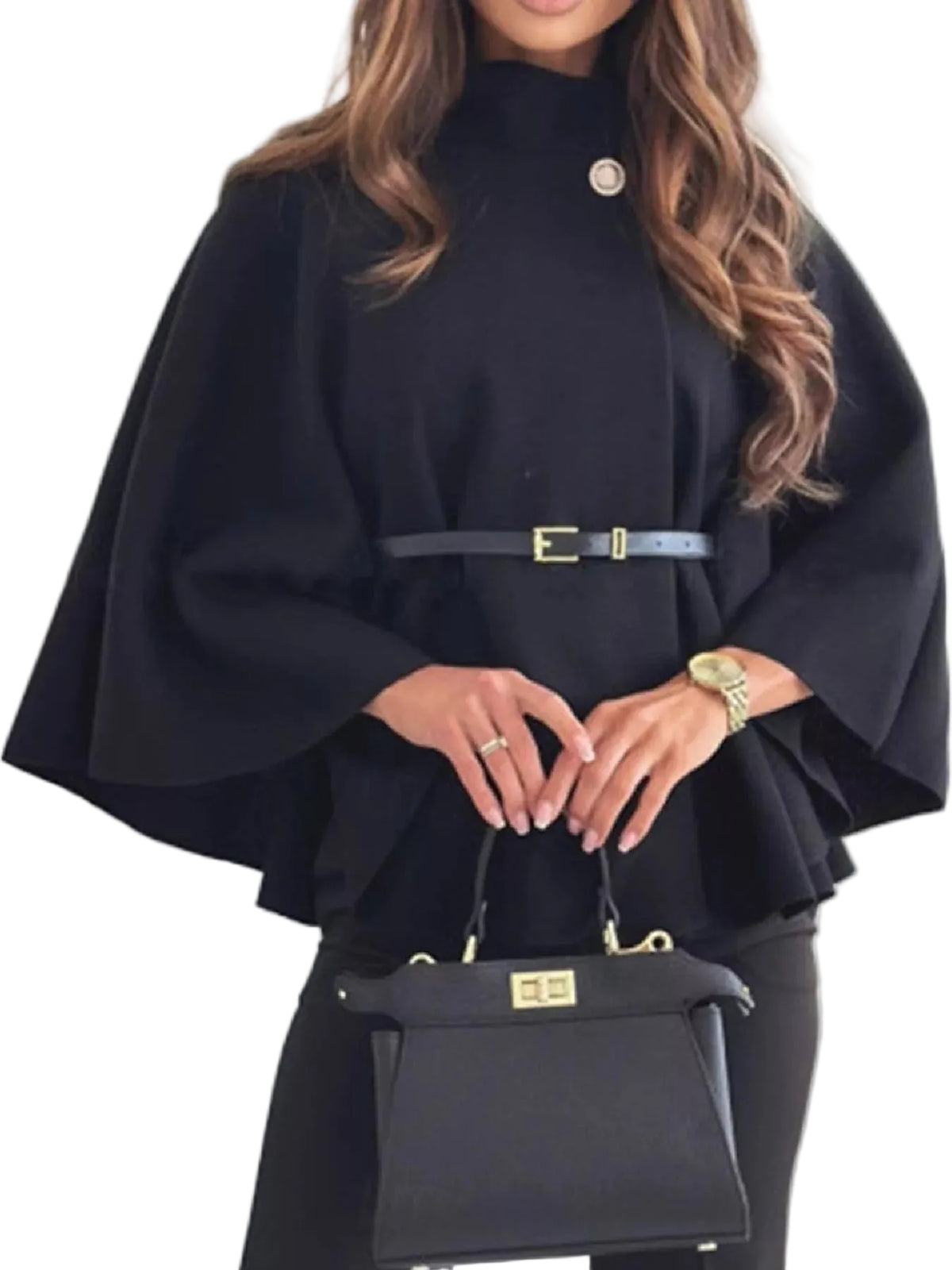 A woman wearing a black high-neck cape-style top with a thin belt at the waist, holding a structured black handbag with gold hardware.