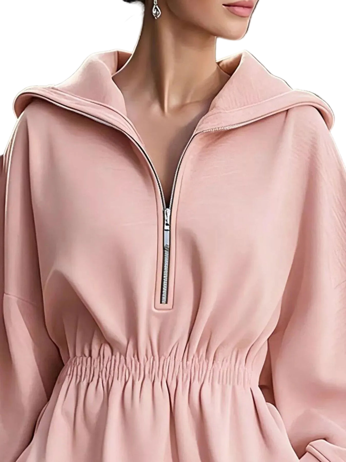 A close-up of a woman wearing a light pink half-zip hoodie dress with a drawstring hood and a gathered elastic waist.