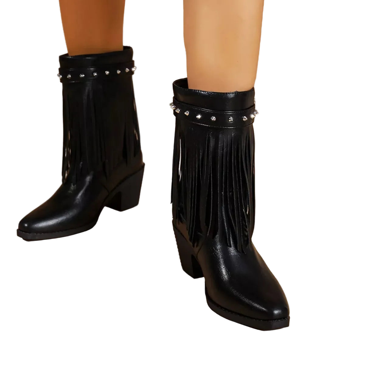 Black faux-leather ankle boots with fringe detailing, a block heel, and silver rhinestone trim, shown on a model's feet against a beige studio background.