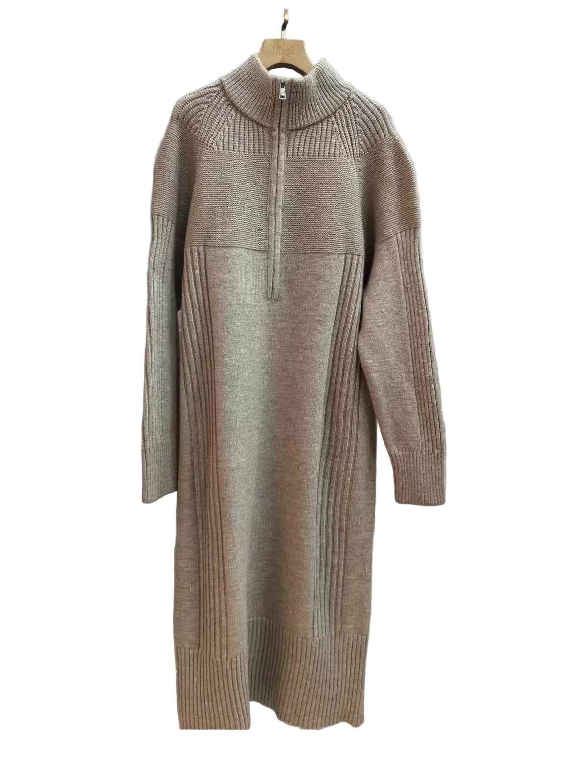 A taupe knit mock-neck sweater dress with a half-zip at the collar, hanging on a wooden hanger against a gray wood-grain tiled wall.