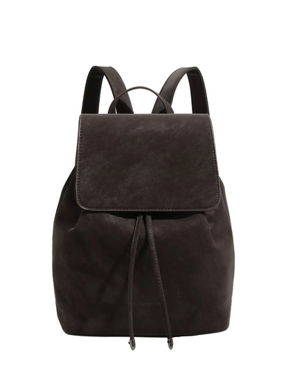 A dark brown suede backpack with a front flap and drawstring closure, photographed against a clean white background.