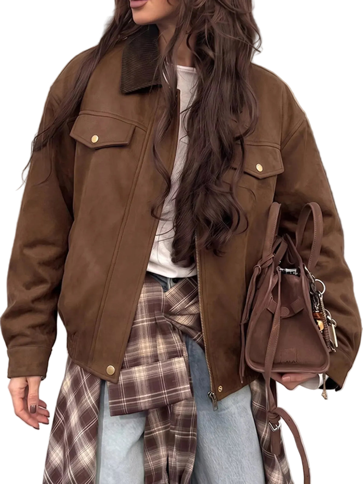 A woman wearing an oversized brown suede-like jacket with flap chest pockets and gold-tone snap buttons, layered over a white top and light blue jeans. A brown plaid shirt is tied around her waist, and she carries a brown handbag.