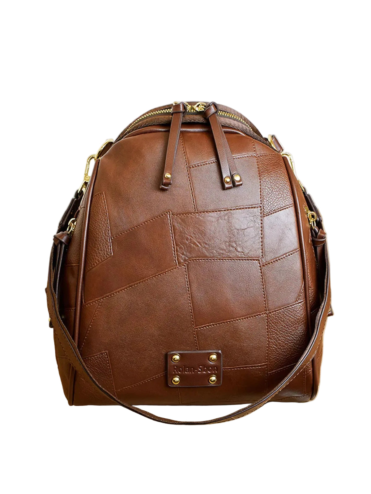 A brown leather backpack with a patchwork quilted pattern, gold-tone hardware, and a front logo plate reading 'Rimac', displayed on a light wood surface.
