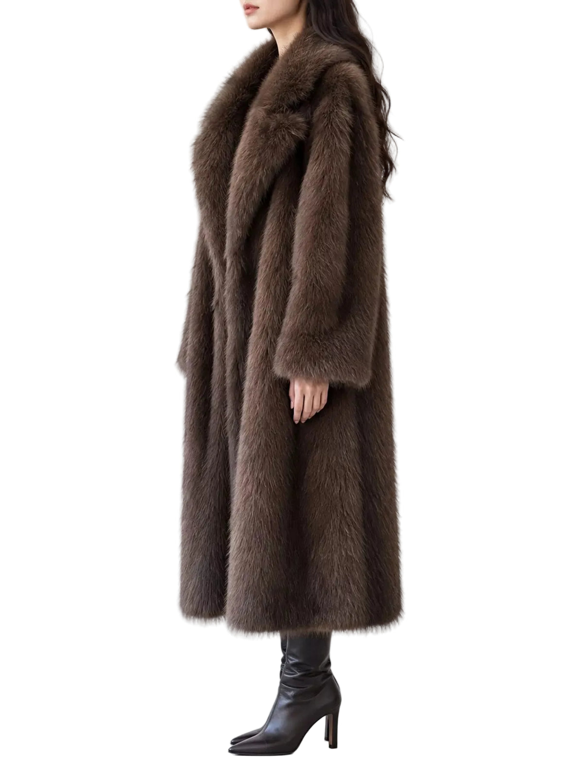 A woman wearing a long, plush brown fur coat with a wide collar and black knee-high heeled boots, standing against a plain light gray studio background.