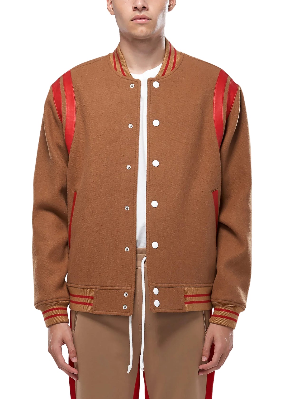 Person wearing a brown varsity jacket with red accents on a white background