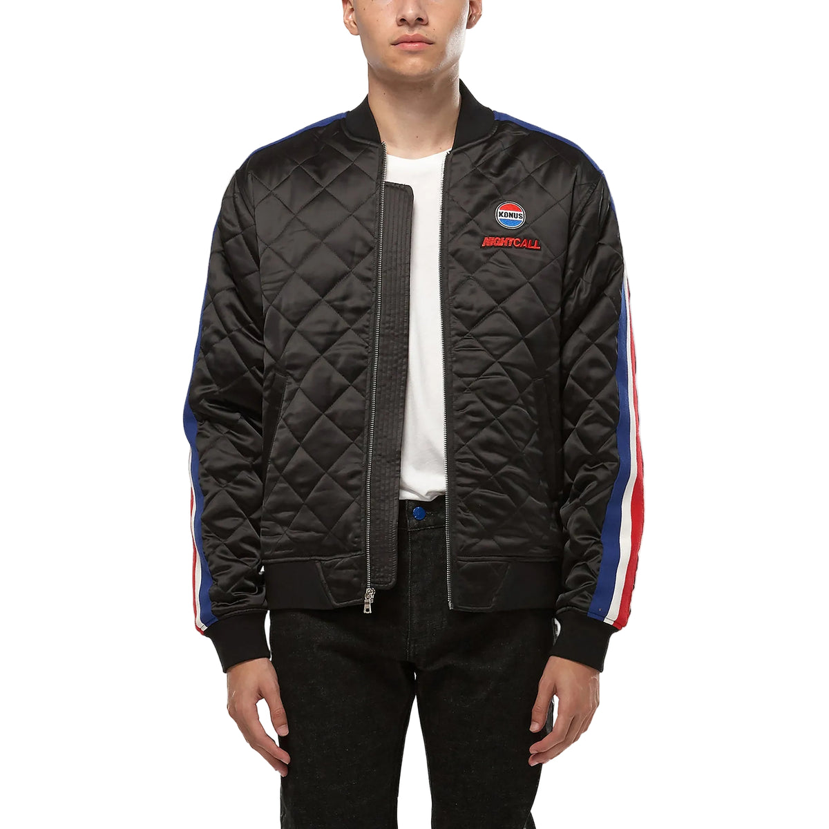 Black quilted jacket with colorful stripes on sleeves worn by a person on a white background