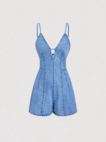 A light blue denim romper with thin spaghetti straps, a deep V-neckline, and decorative contrast stitching, shown against a plain light gray background.