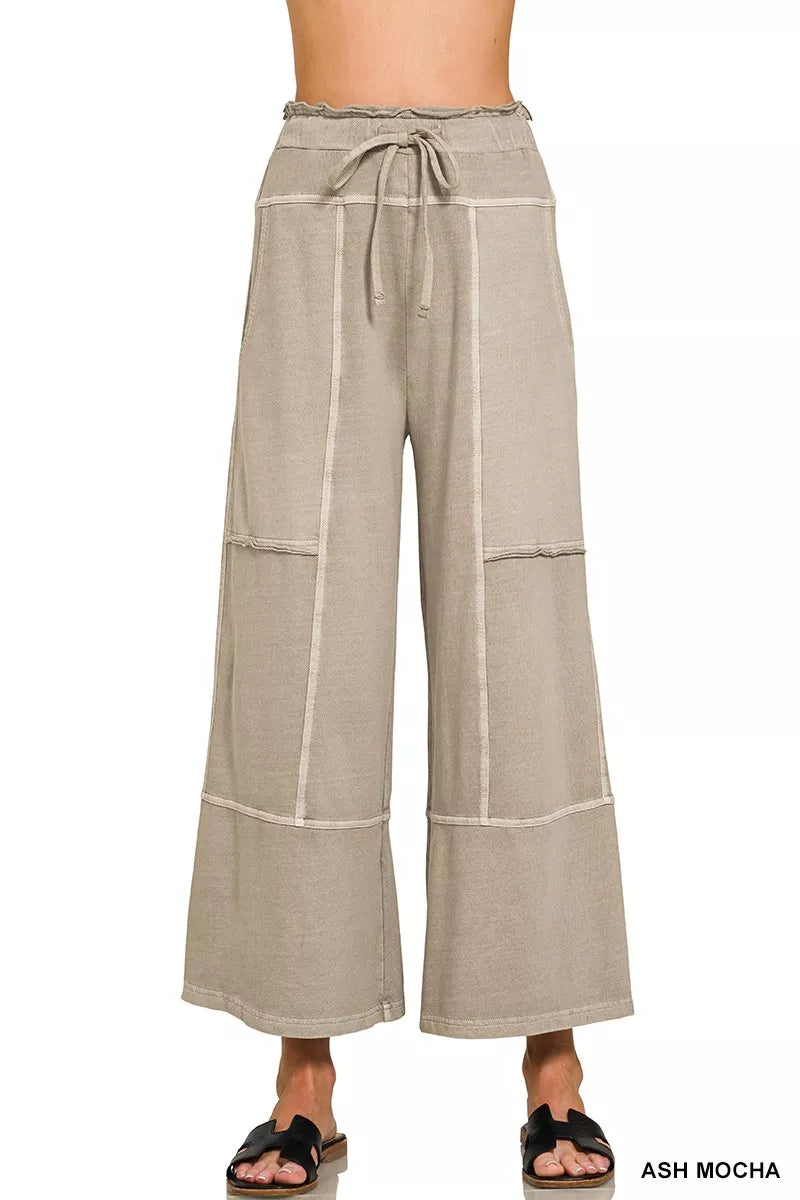 Beige wide-leg pants with a tie waist on a white background