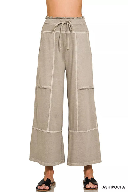 Beige wide-leg pants with a tie waist on a white background