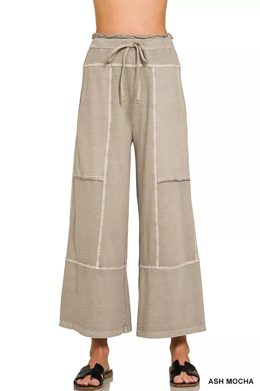 Beige wide-leg pants with a tie waist on a white background