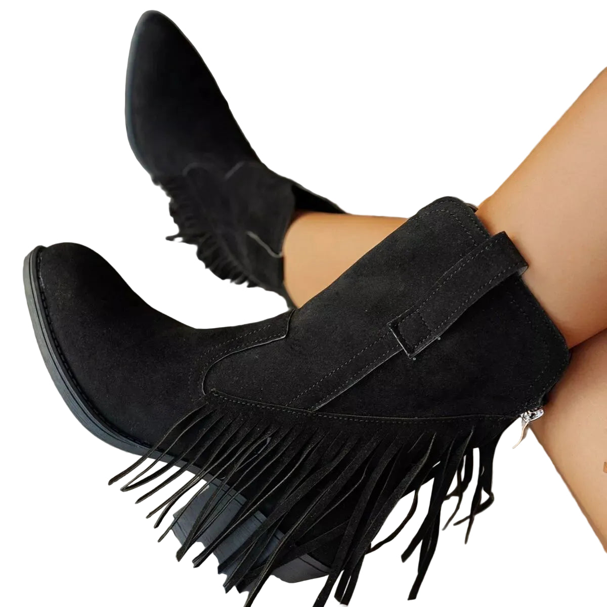 Black suede ankle boots with fringe detailing and a low block heel, shown on a model's feet over a gray wooden deck.