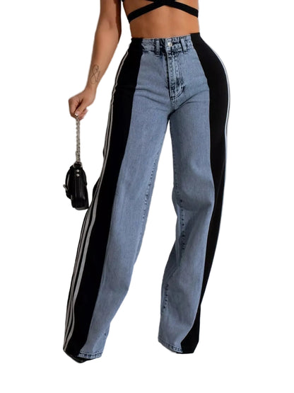 A model wearing high-waisted wide-leg jeans with a light blue denim body and bold black side panels, holding a small black handbag against a light gray studio background.
