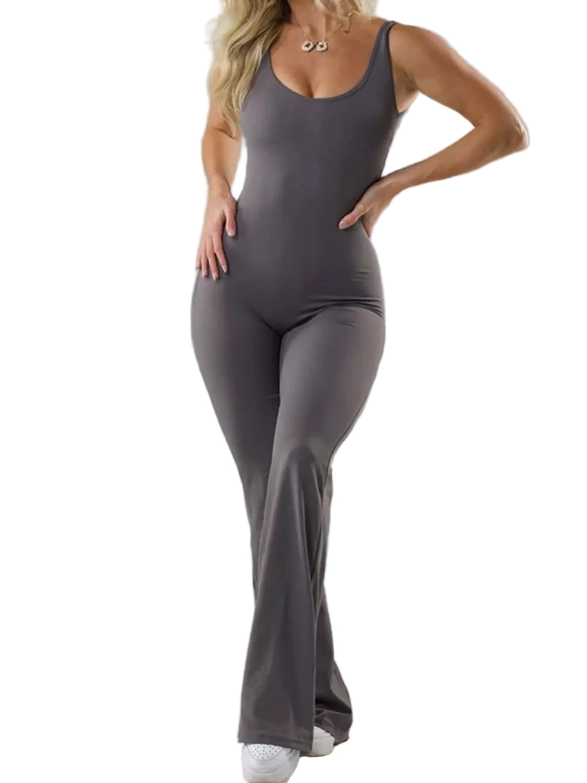 A woman modeling a dark gray sleeveless jumpsuit with a scoop neckline and wide-leg pants, standing against a light gray studio background.