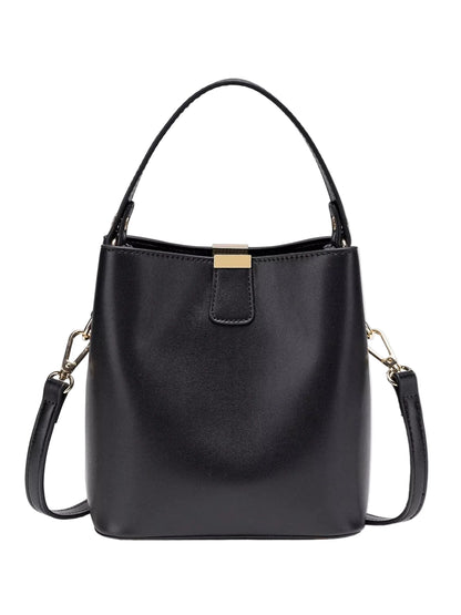 A black leather bucket handbag with a top handle, a detachable shoulder strap, and a gold-tone metal clasp on the front, shown against a plain white background.