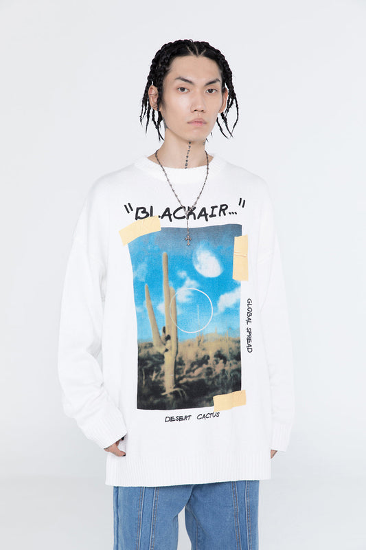 Person wearing a white sweatshirt with graphic design and text