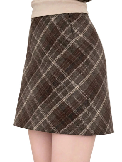 A brown and beige plaid A-line mini skirt worn by a model, shown from the waist down against a plain white background.