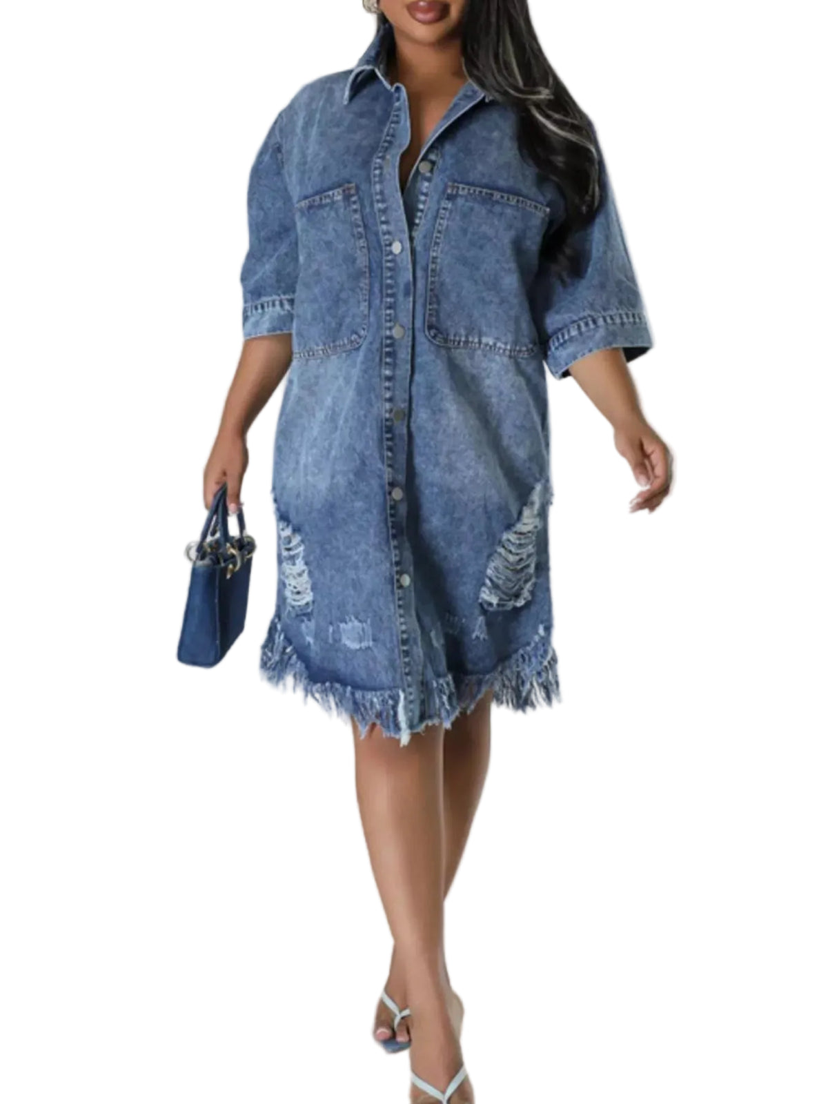 A woman models a distressed blue denim shirt dress with rolled sleeves and a frayed hem, holding a matching blue handbag against a light gray studio background.