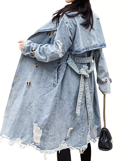A woman wearing a light-wash distressed denim trench coat with a tie waist belt, shown from the back against a plain white background.