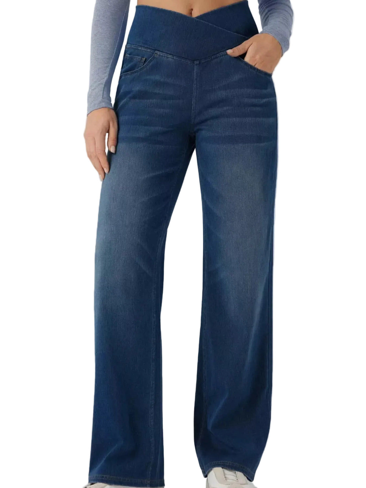 A person wearing dark blue wide-leg denim jeans with a crossover waistband, paired with a gray long-sleeve crop top and white sneakers, shown against a light gray studio background.