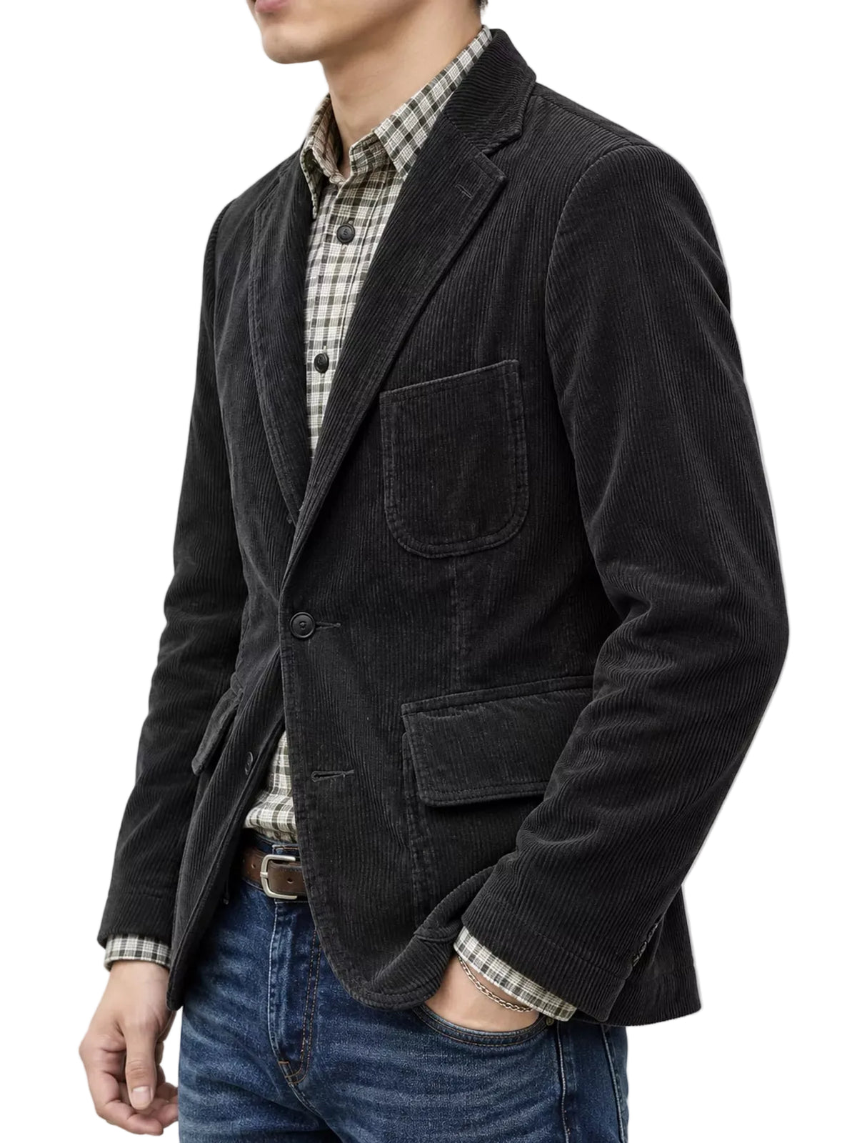 A man wearing a black corduroy blazer over a beige and black checkered shirt, paired with blue jeans, shown from the chest down against a plain white background.
