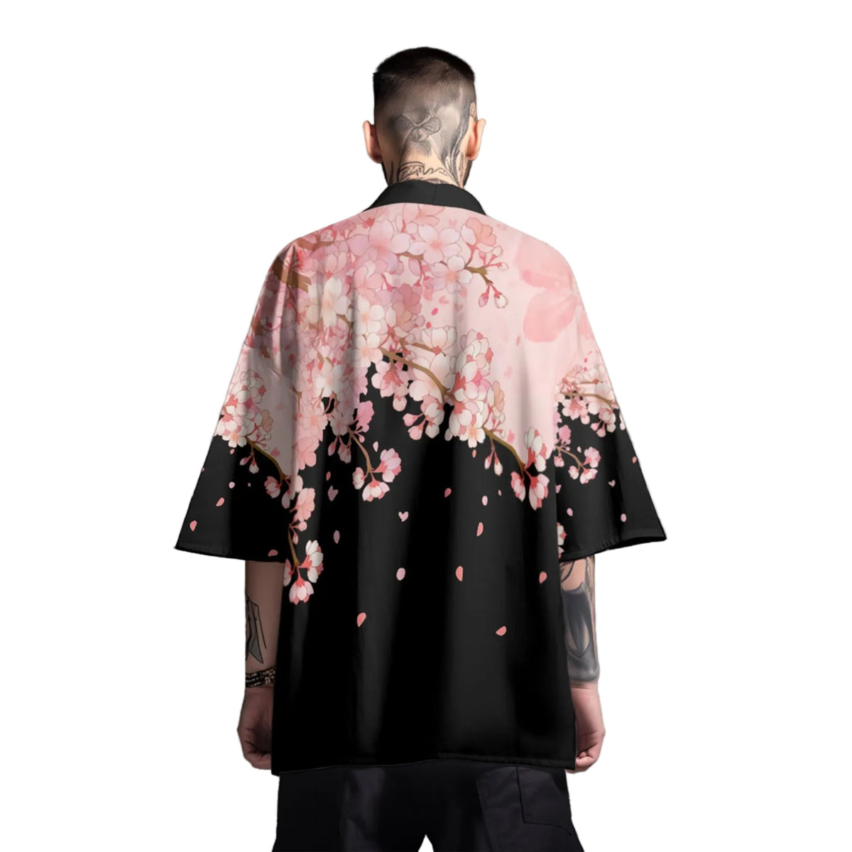 Person wearing a black kimono with pink cherry blossom design on a gray background