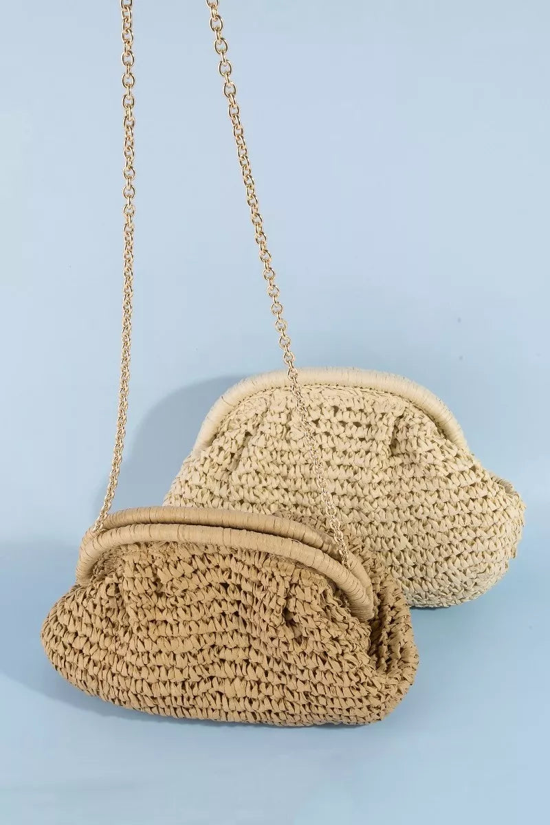 Beige woven handbag with a chain strap on a light blue background