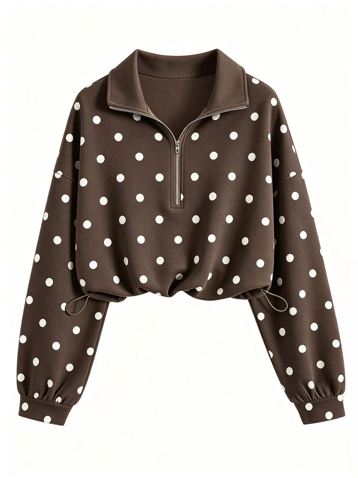 A cropped long-sleeve quarter-zip pullover in dark brown with a white polka dot pattern, featuring a mock neck and drawstring hem, shown against a plain white background.