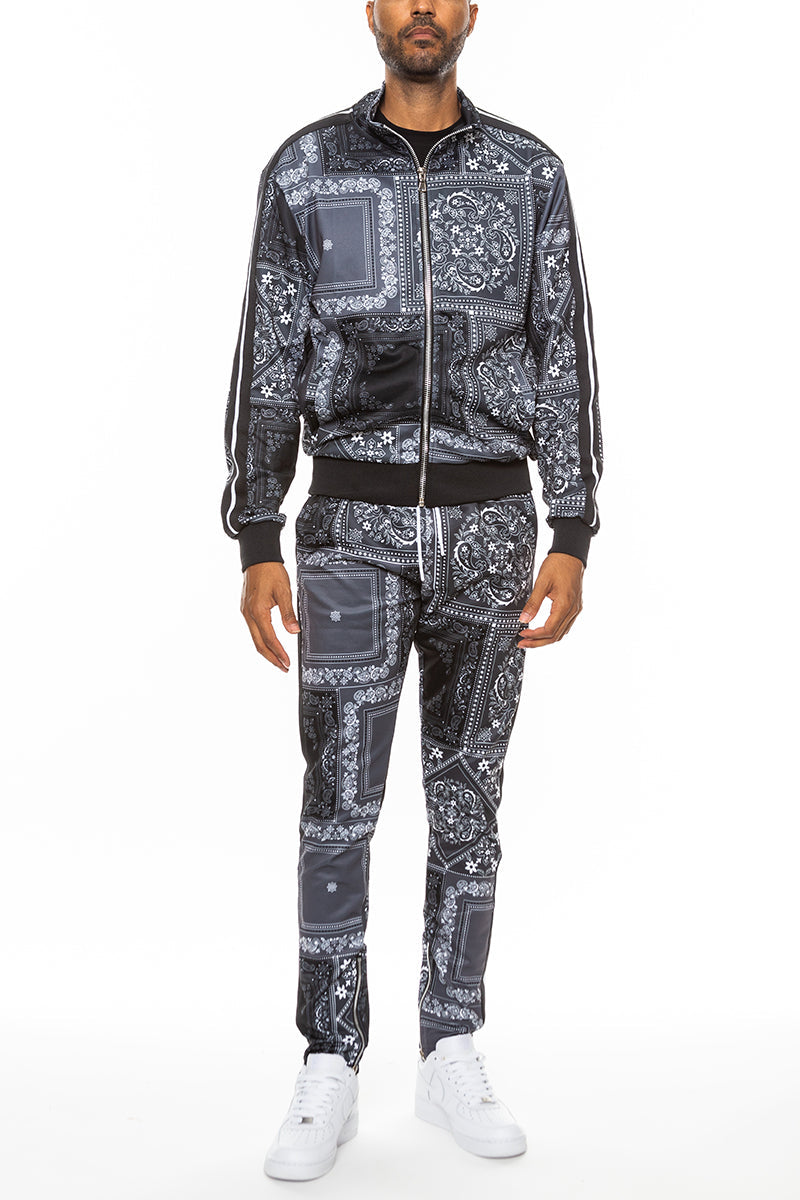 Man wearing a black and white patterned tracksuit on a white background