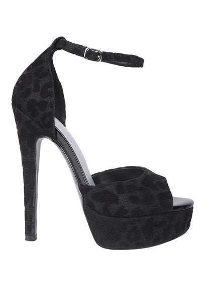 Black high-heeled platform shoe with leopard print pattern on a white background