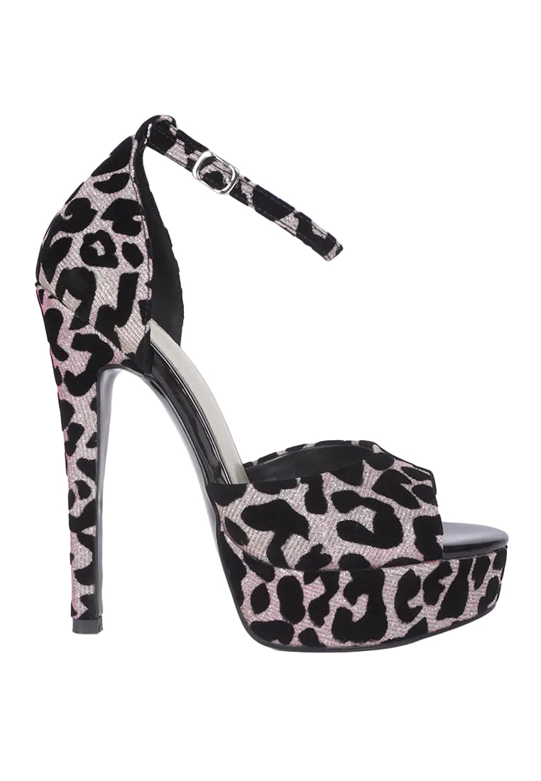 A single high-heeled platform sandal with an ankle strap, featuring a black and light pink leopard print pattern, shown against a plain light gray background.