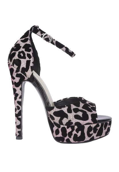 A single high-heeled platform sandal with an ankle strap, featuring a black and light pink leopard print pattern, shown against a plain light gray background.